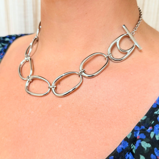 Model wearing Little Nell Silver Pebble Link Statement Necklace, highlighting its modern design