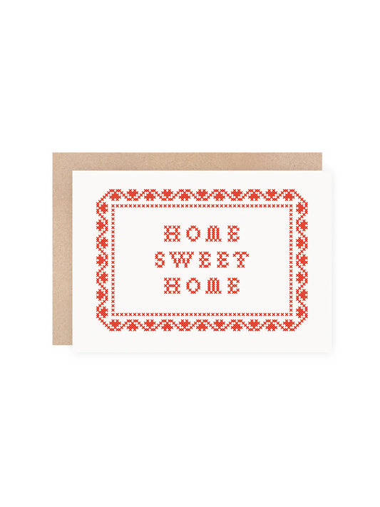 Close up of red screenprinted folk art sampler card