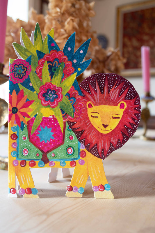 Detailed close-up of the 'Lion Parade' die-cut greetings card, highlighting the vibrant illustration and unique shape.