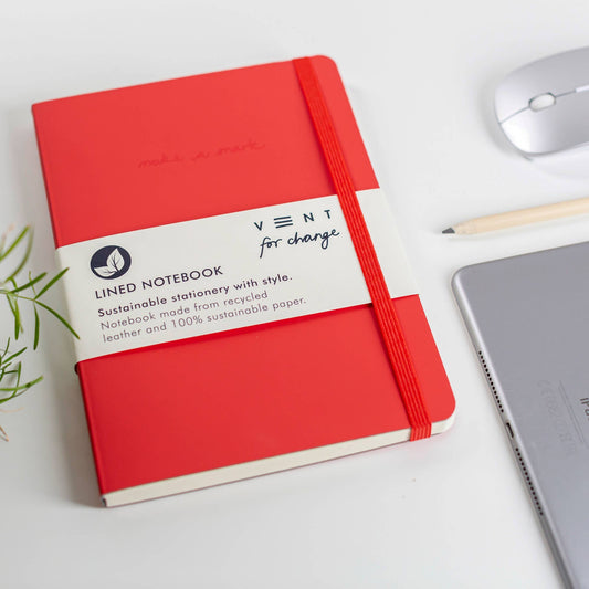 Close-up of Merry Christmas bookmark on recycled leather notebook