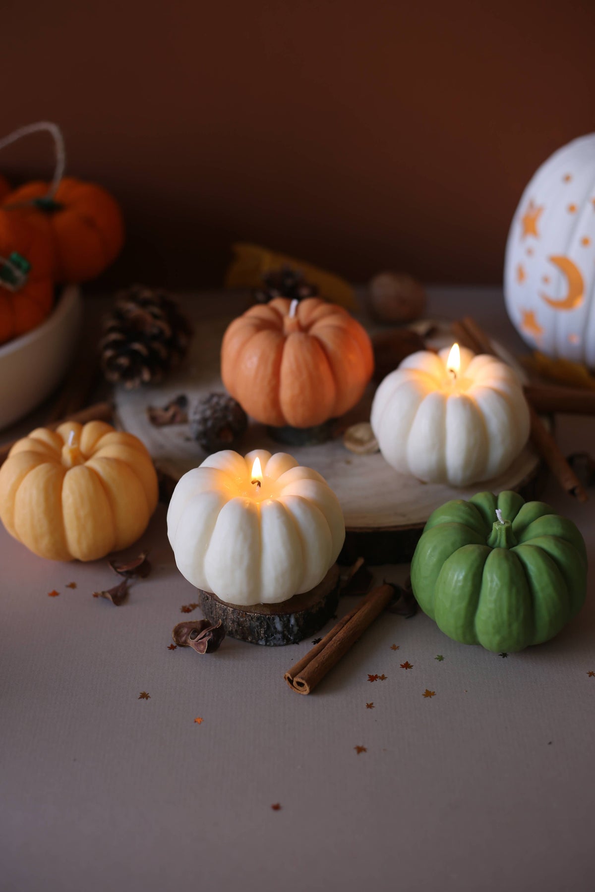 Scented pumpkin candle in a cosy autumnal setting