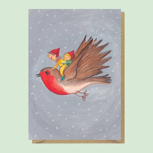 Illustrated card of Elves riding a Robin Yo ho ho. These elves are all dressed up for winter having the time of their life riding a robin across the snowy sky.