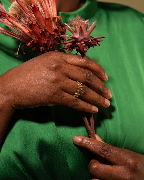 Ethically made in Kenya, brass ring in a zig zag pattern. As seen on models hand.