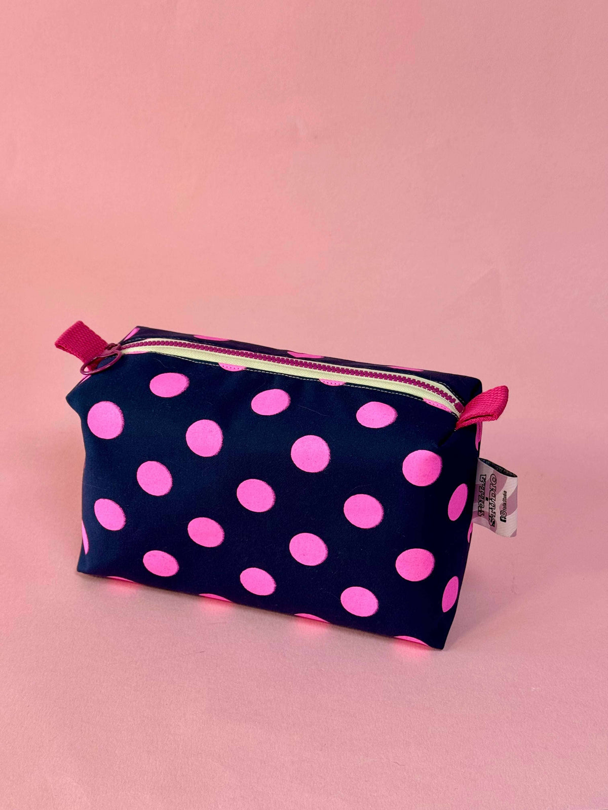 Pink and navy blue polka dot boxy travel pouch