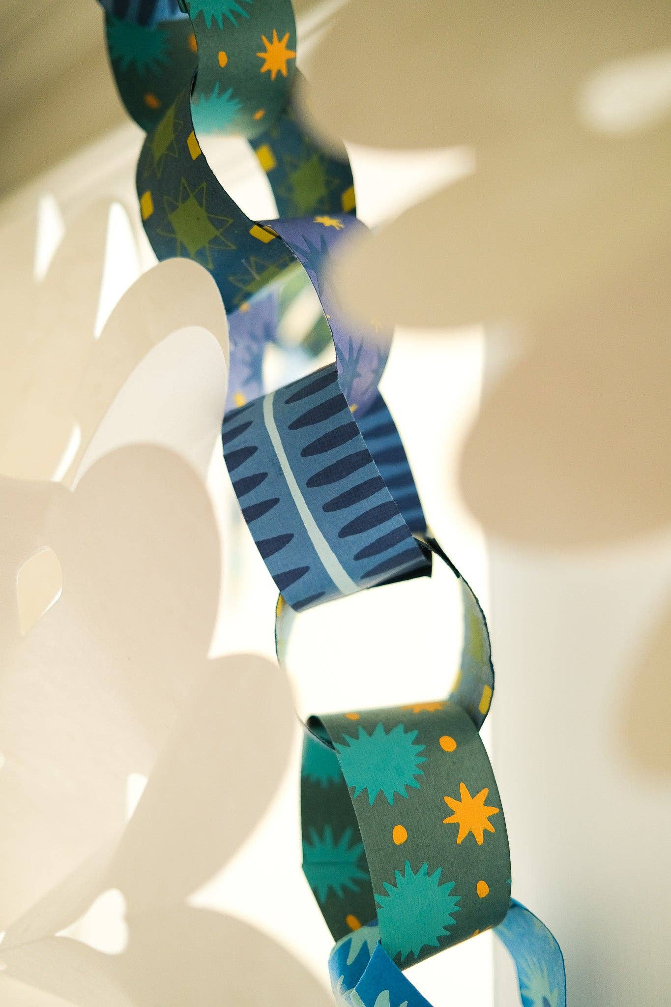 Variety of blue and yellow patterns on recycled paper chain strips