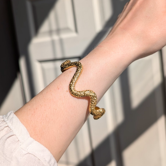 Adjustable gold wave bangle with textured dimple detail