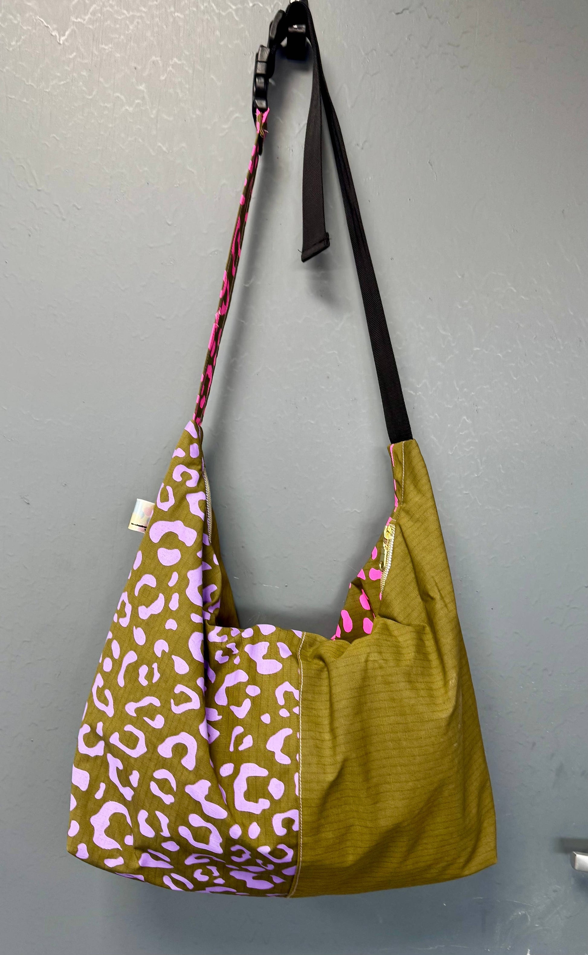 Model wearing Yolla Studio Leopard Print Crossbody Bag, adjustable strap visible.