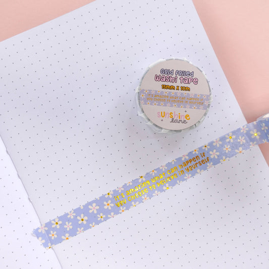 Close-up of gold foil quote on blue floral washi tape