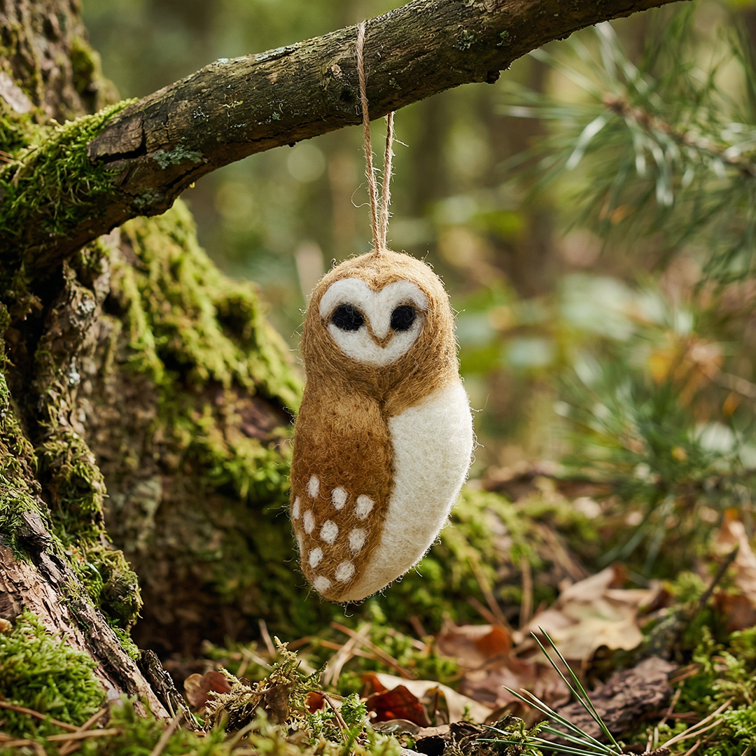 Handmade felt barn owl hanging decoration hanging on a branch
