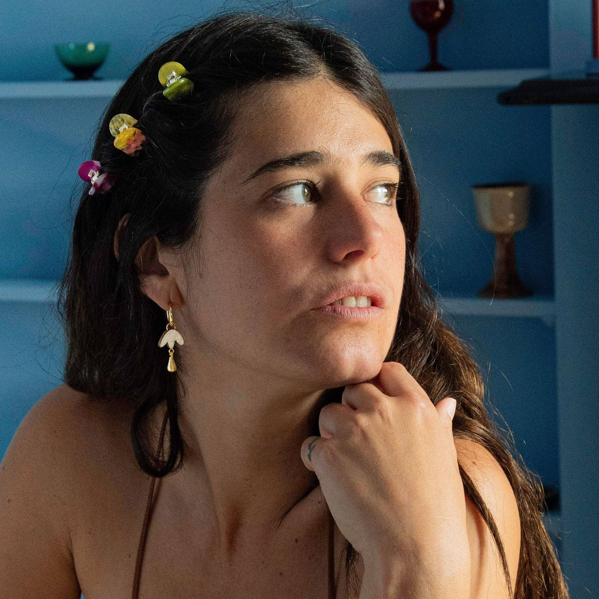 Model wearing petal drop hoop earrings