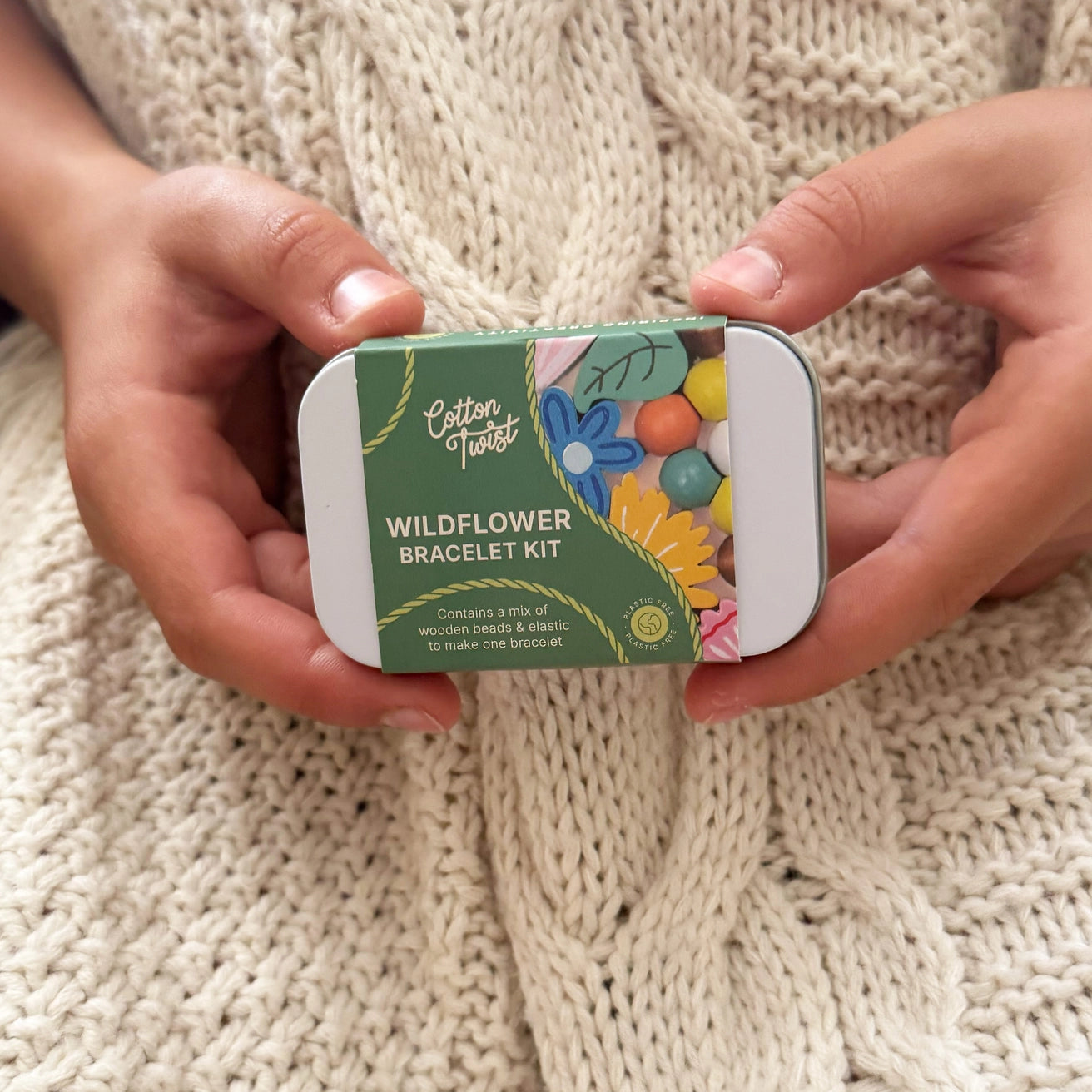 Wildflower bracelet making kit in a rectangular hinged tin, featuring wooden beads and elastic.