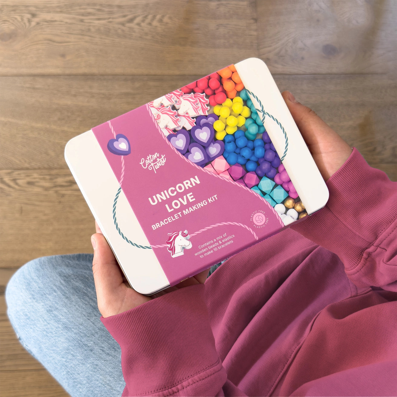 Person holding a Unicorn Love bracelet making kit by Cotton Twist.