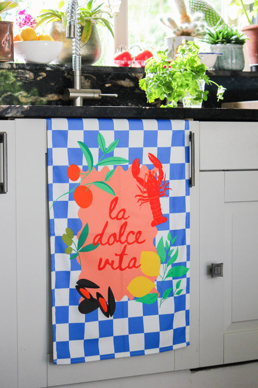 Close up of vibrant seafood and citrus illustrations on kitchen towel