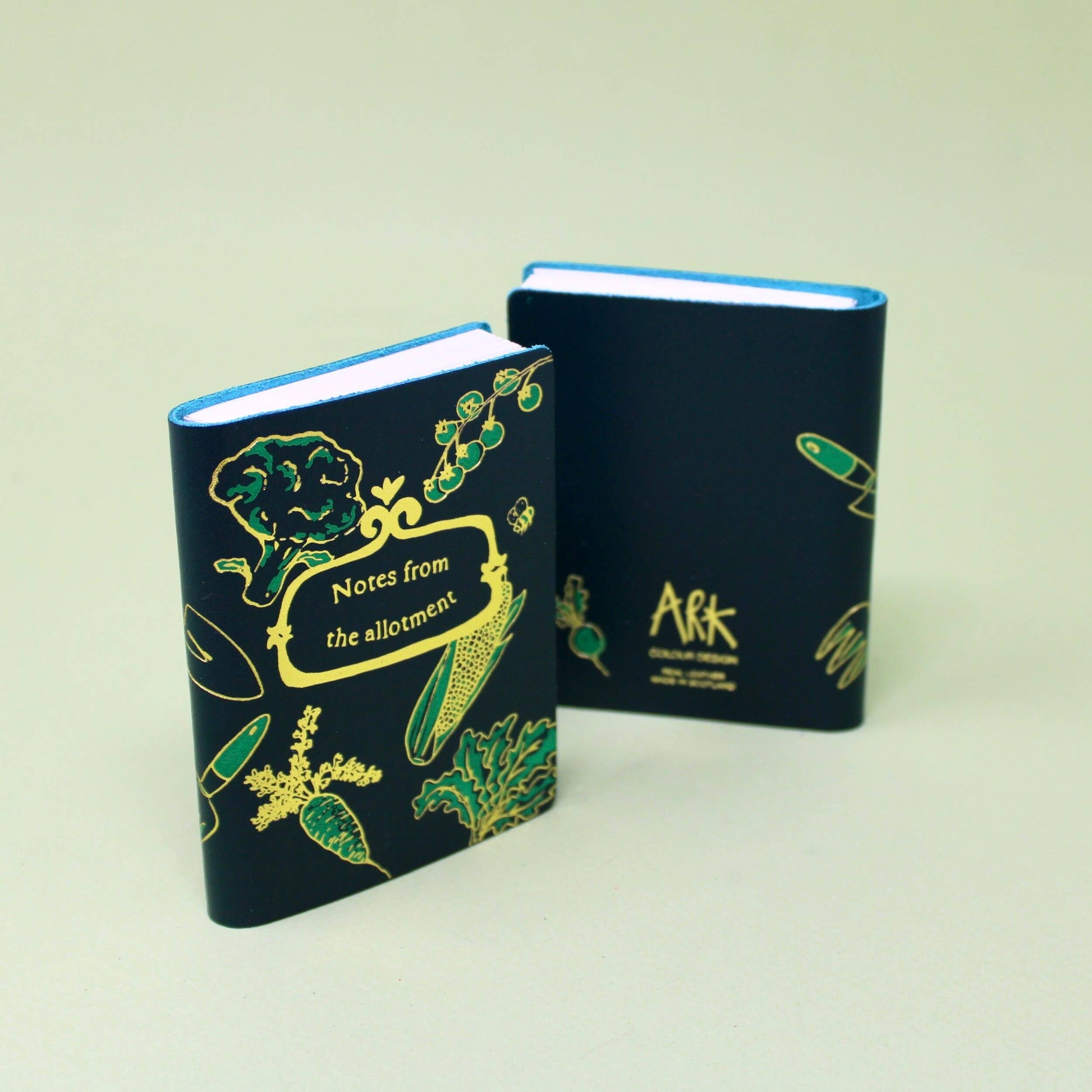 Midi leather journal with gold foil illustration, handmade in Scotland using ethical leather by Ark Colour Design. Blue leather gold embossed Notes from the allotment.