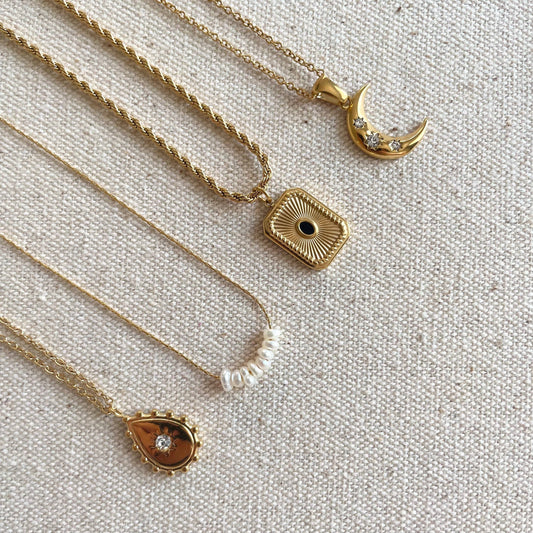 Close-up of delicate gold-plated chain with eight natural pearl beads