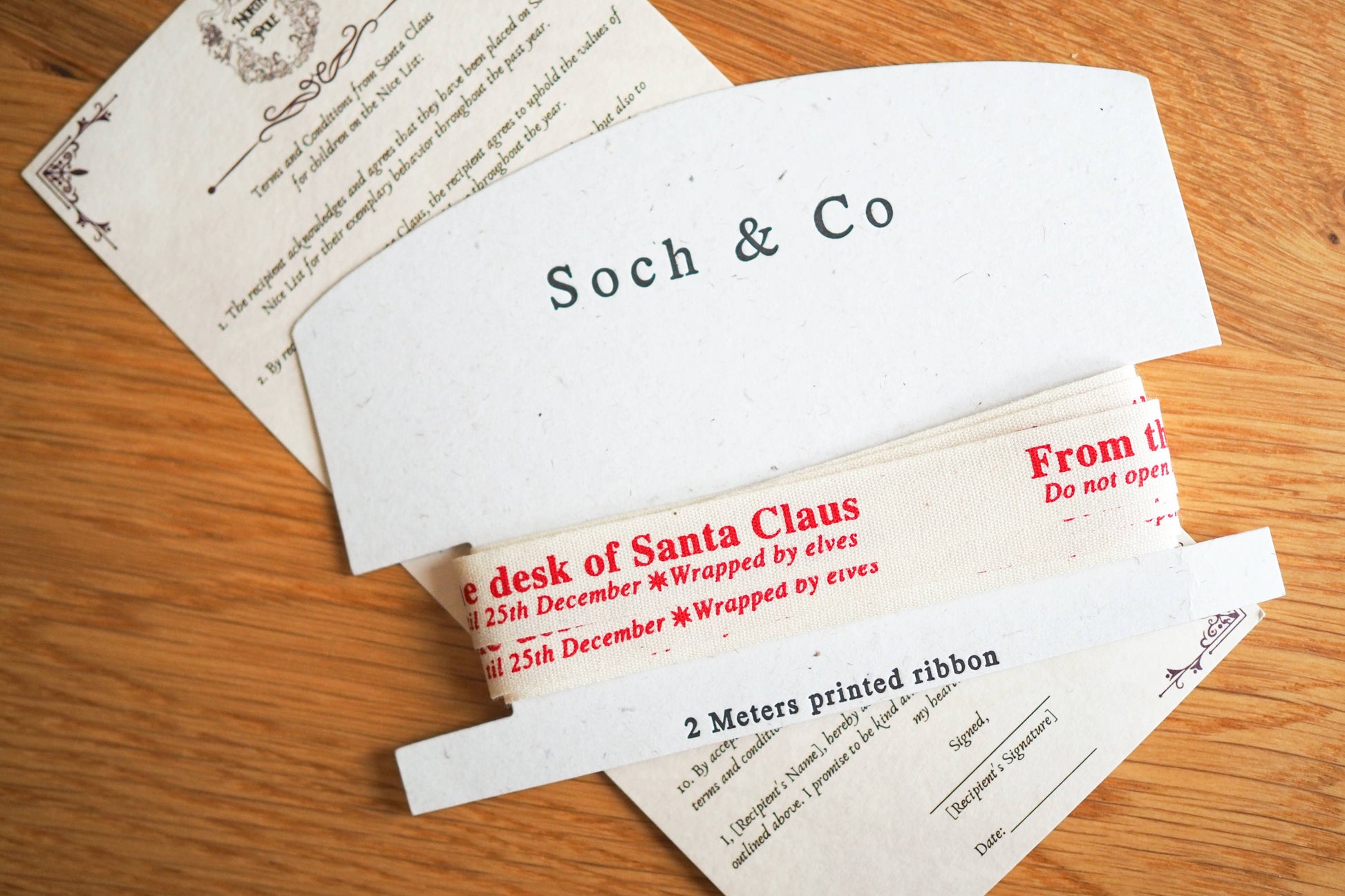Envelopes and documents with 'Soch & Co' branding on a wooden surface