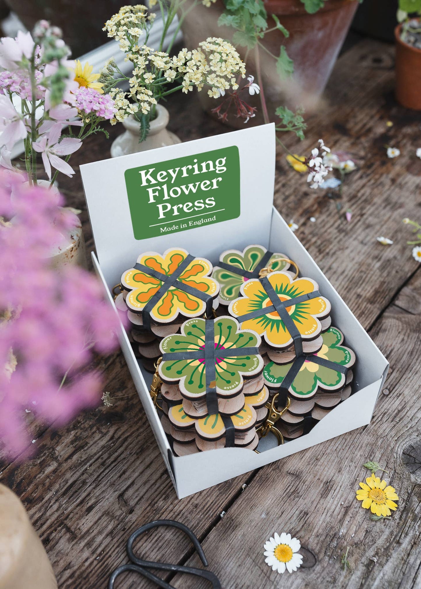 Mini keyring flower press in green and yellow packaging