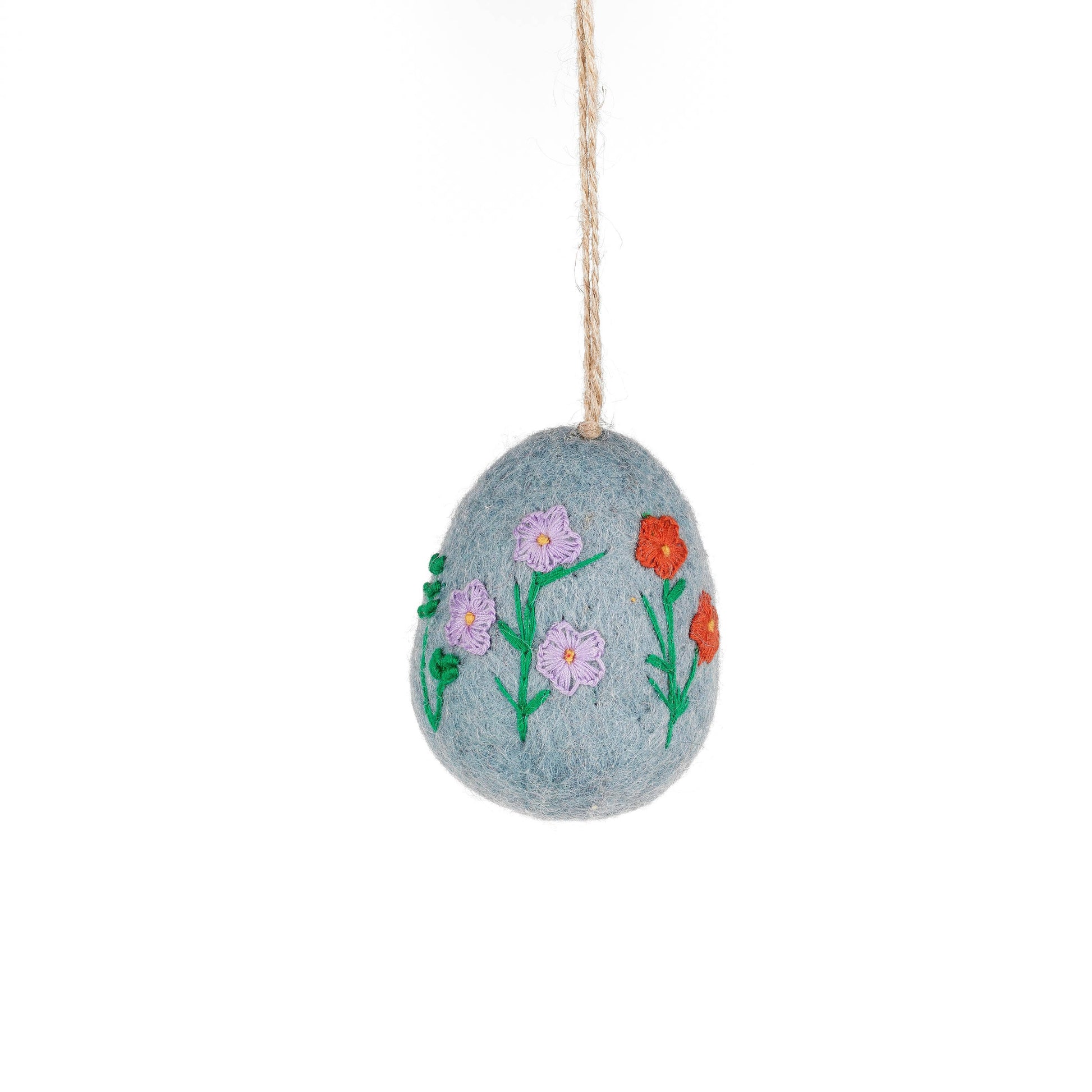 Pale blue hand embroidered felt egg featuring delicate floral embroidery. Each egg is meticulously hand stitched, showcasing intricate details and vibrant colours that will add a touch of elegance to your home.