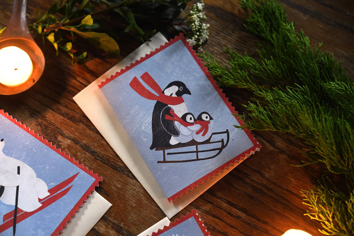 Playful Penguin Family on Sled Christmas Card Close-up