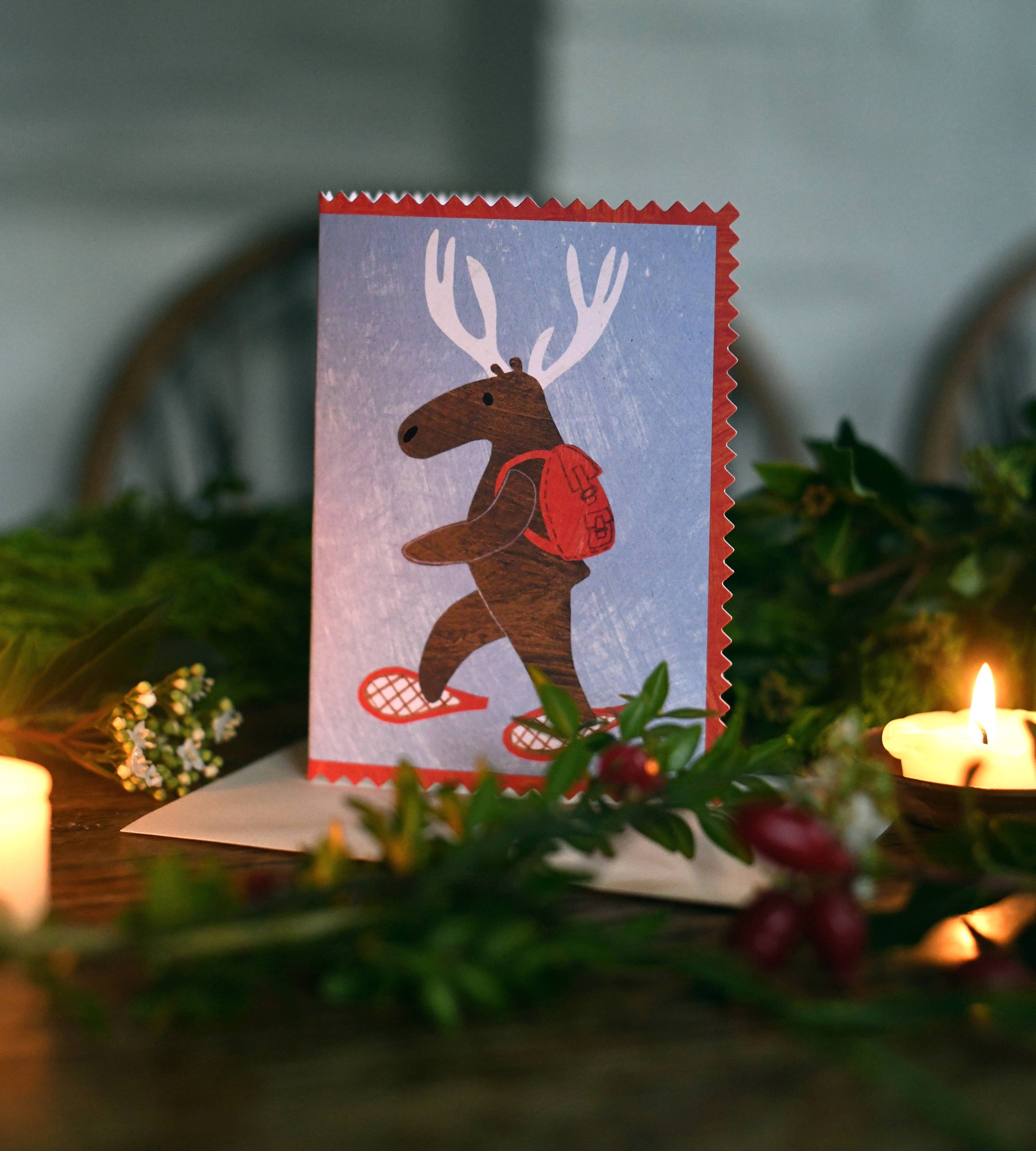 Close-up of snowshoeing deer Christmas card design, sustainable paper