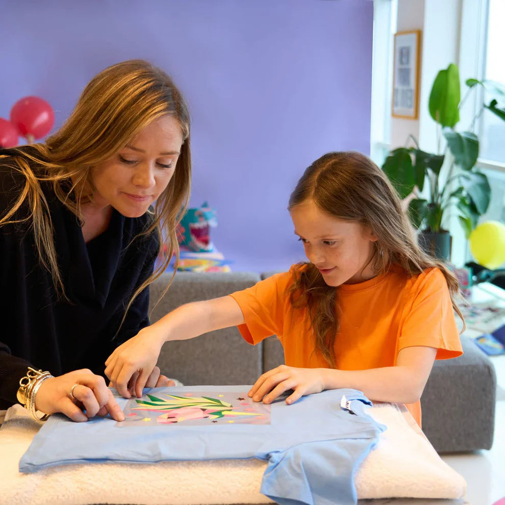 Example of a child proudly holding a 100% cotton tote bag customised with a Llama Popkit design.