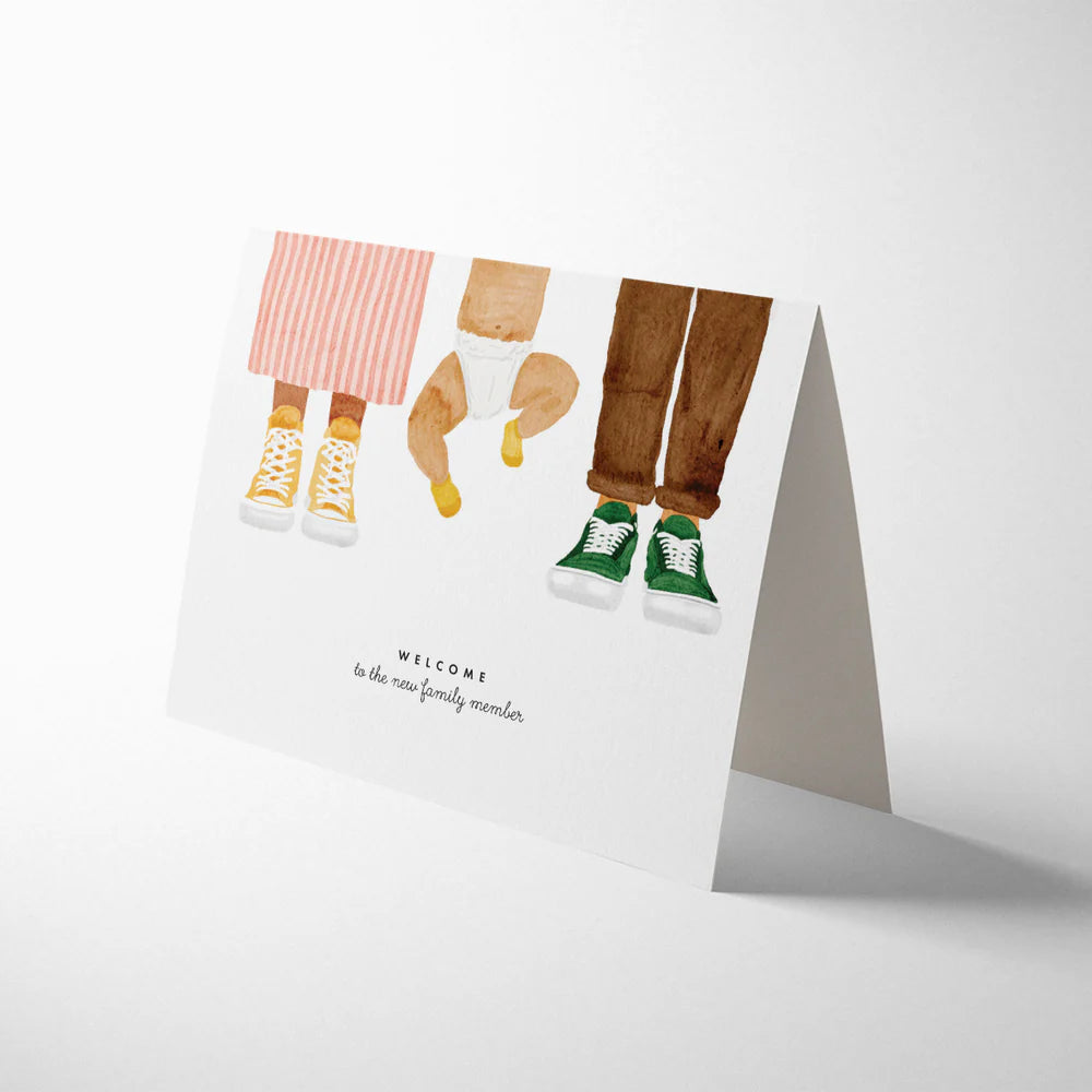 Modern new baby card with tiny socks design and kraft envelope