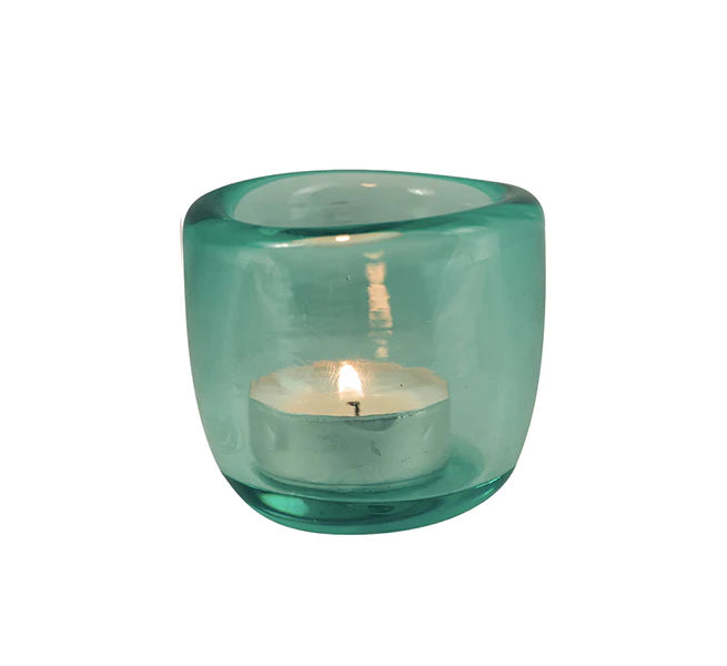 A collection of hand-blown glass tealight holders in assorted colors, including blue, green, and purple, with etched designs on the base.
