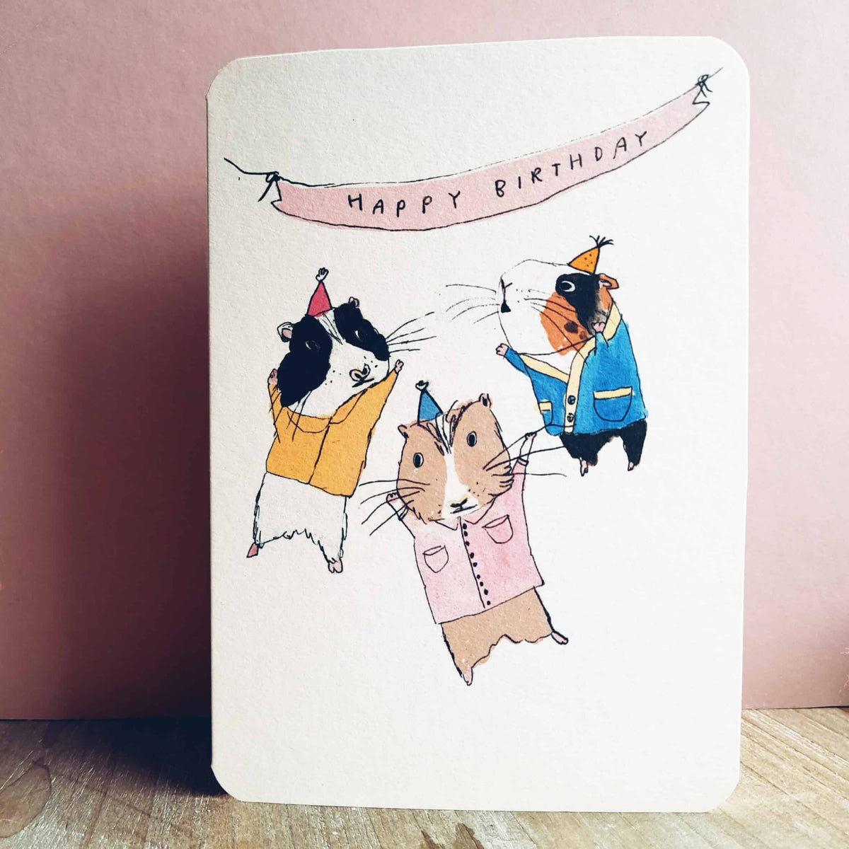 Birthday Guinea Pig Party Card by Laura Skillbeck featuring three guinea pigs in party hats