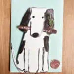 Playful dog birthday card with a removable stick and ball