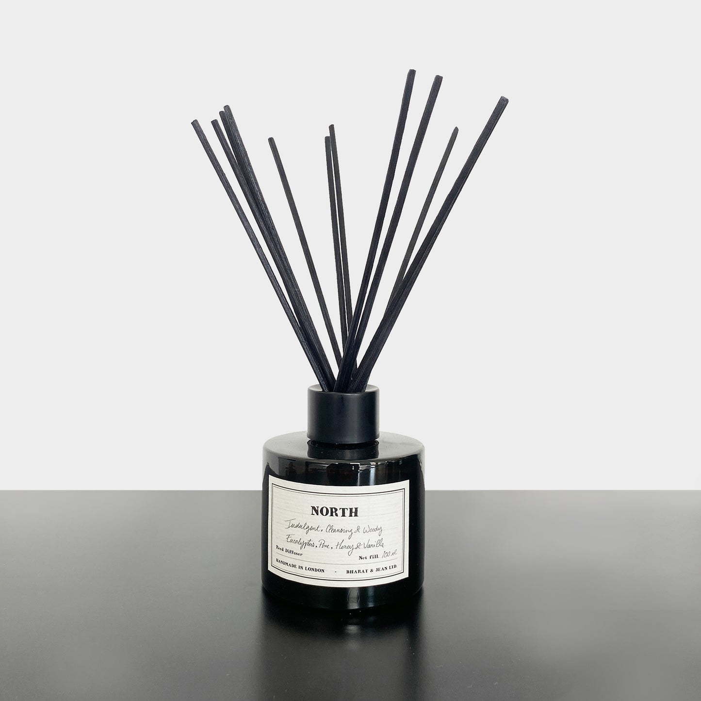 Bharat & Jean North Reed Diffuser in amber glass bottle