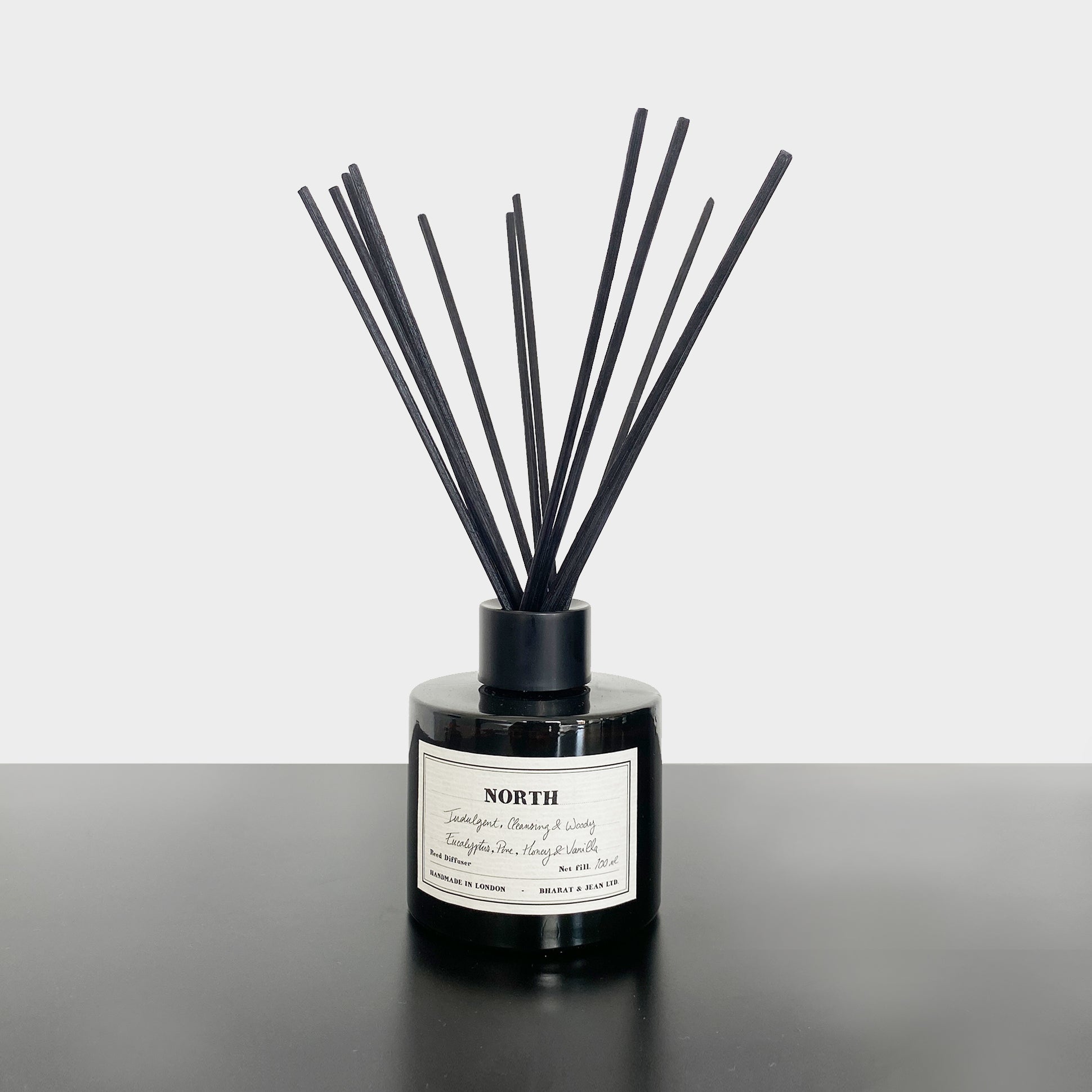 Bharat & Jean North Reed Diffuser in amber glass bottle