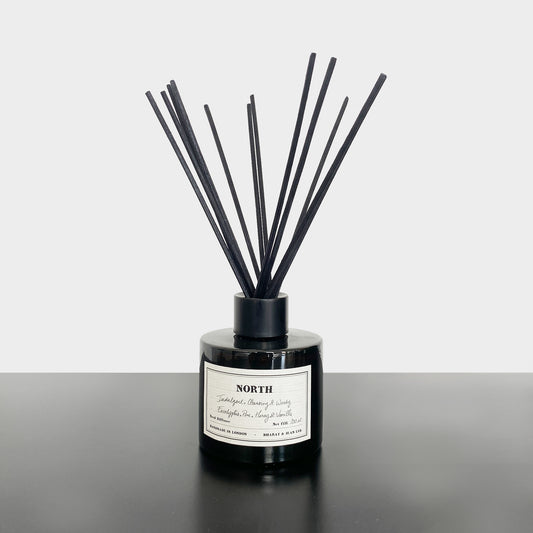 Bharat & Jean North Reed Diffuser in amber glass bottle