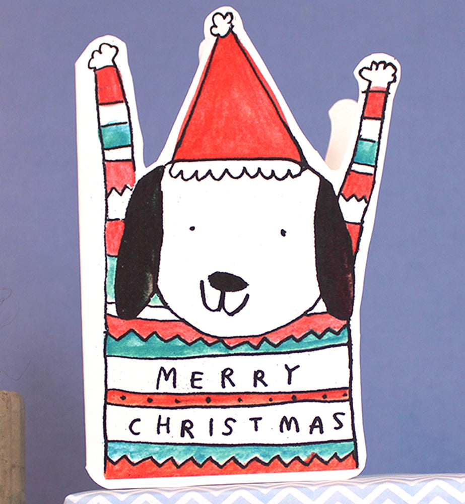 Playful cut-out Christmas card featuring a dog wearing a festive jumper, by Laura Skillbeck
