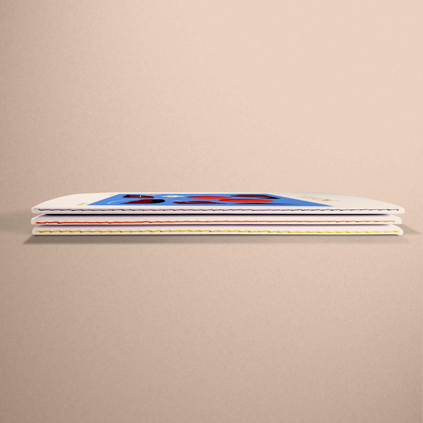 Stack of Darling Clementine A5 stitched notebooks with colourful fruit designs, showcasing their sustainable quality and gold foil details.