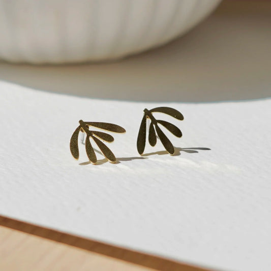 Delicate botanical brass leaf stud earrings from Copper Bee, hypoallergenic stainless steel posts, intricate laser-cut design, lightweight handmade UK jewellery.