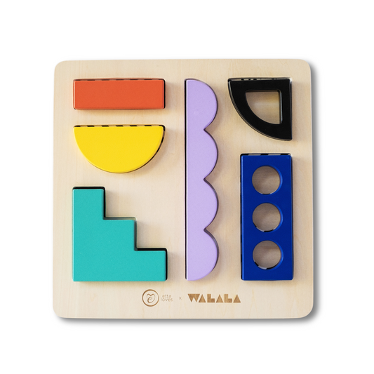 Child's hands playing with Etta Loves x Walala Studio colourful wooden shapes on a sensory puzzle board, revealing monochrome patterns.