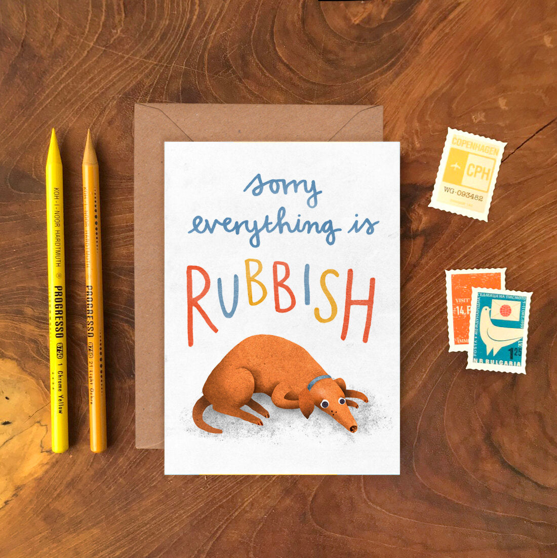 Emily Nash Sorry Everything is Rubbish greeting card with sad dog illustration and recycled kraft envelope, sustainably certified card