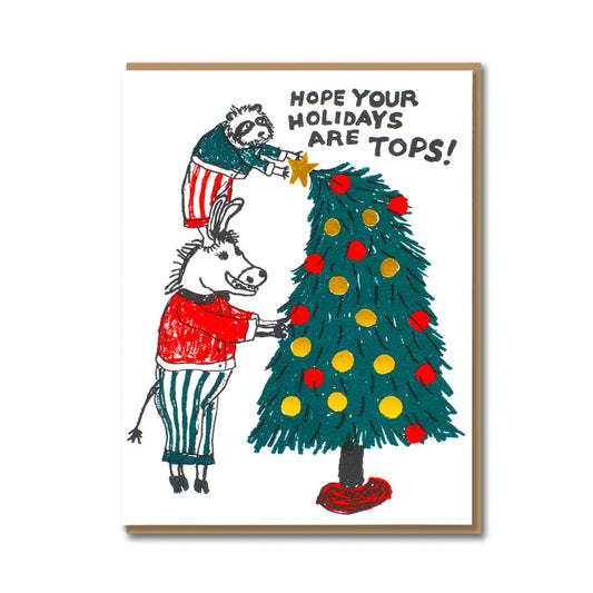 Tops Holiday Tree Animals Christmas card by Egg Press, cartoon raccoon standing on donkey's shoulders placing star on tree, letterpress printed, kraft envelope, sustainably certified paper, 108mm x 140mm.
