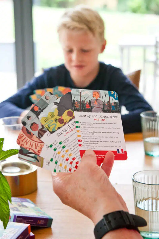 Close-up of History Heroes Children game cards with character illustrations and facts