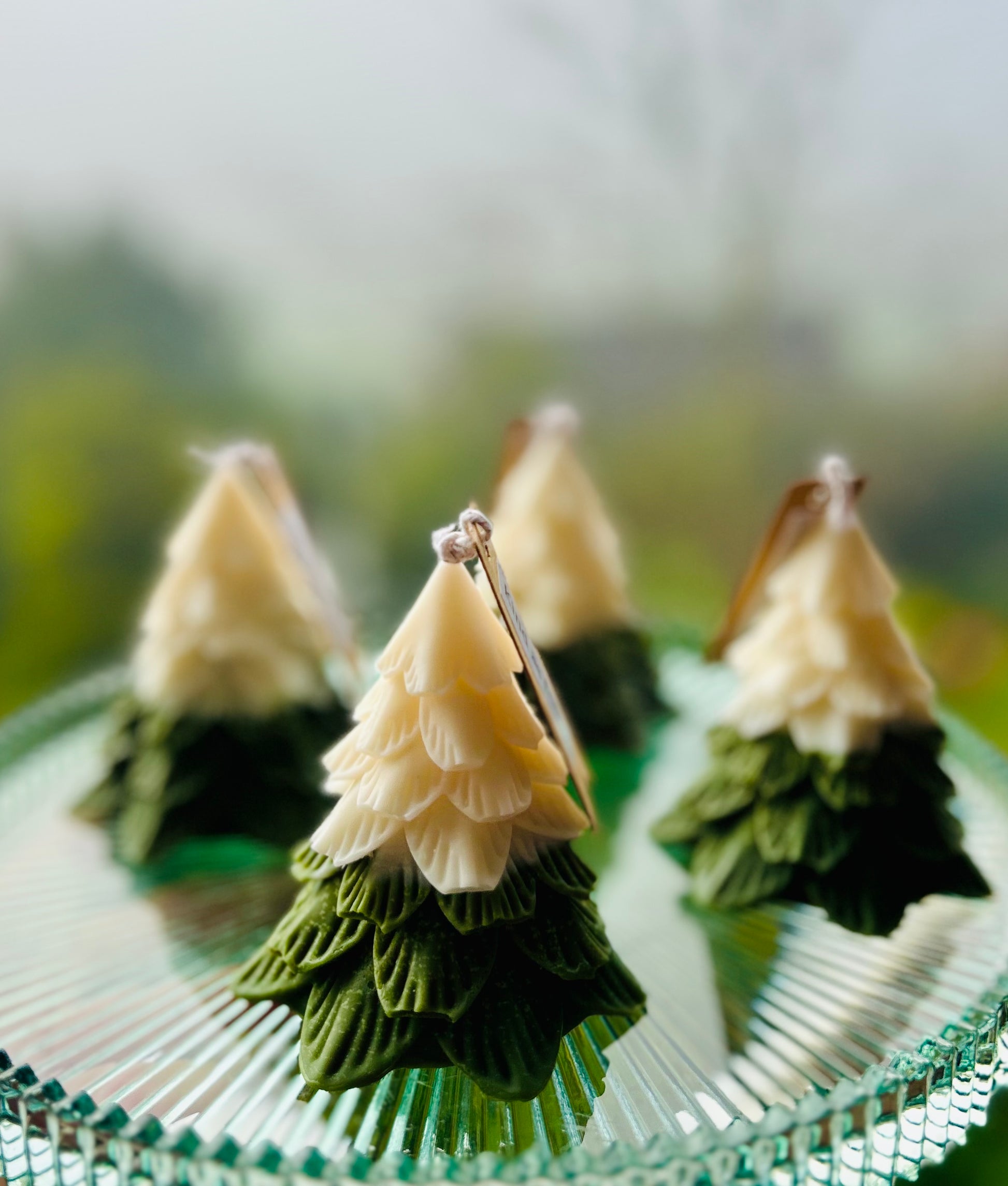 Kind As Folk Handmade Soy Wax Christmas Tree Candle, front view in a festive setting