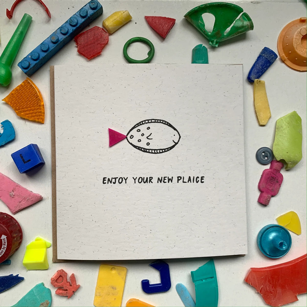 Unique 'Enjoy Your New Plaice' greeting card handmade with recycled microplastics, perfect for new home celebrations.
