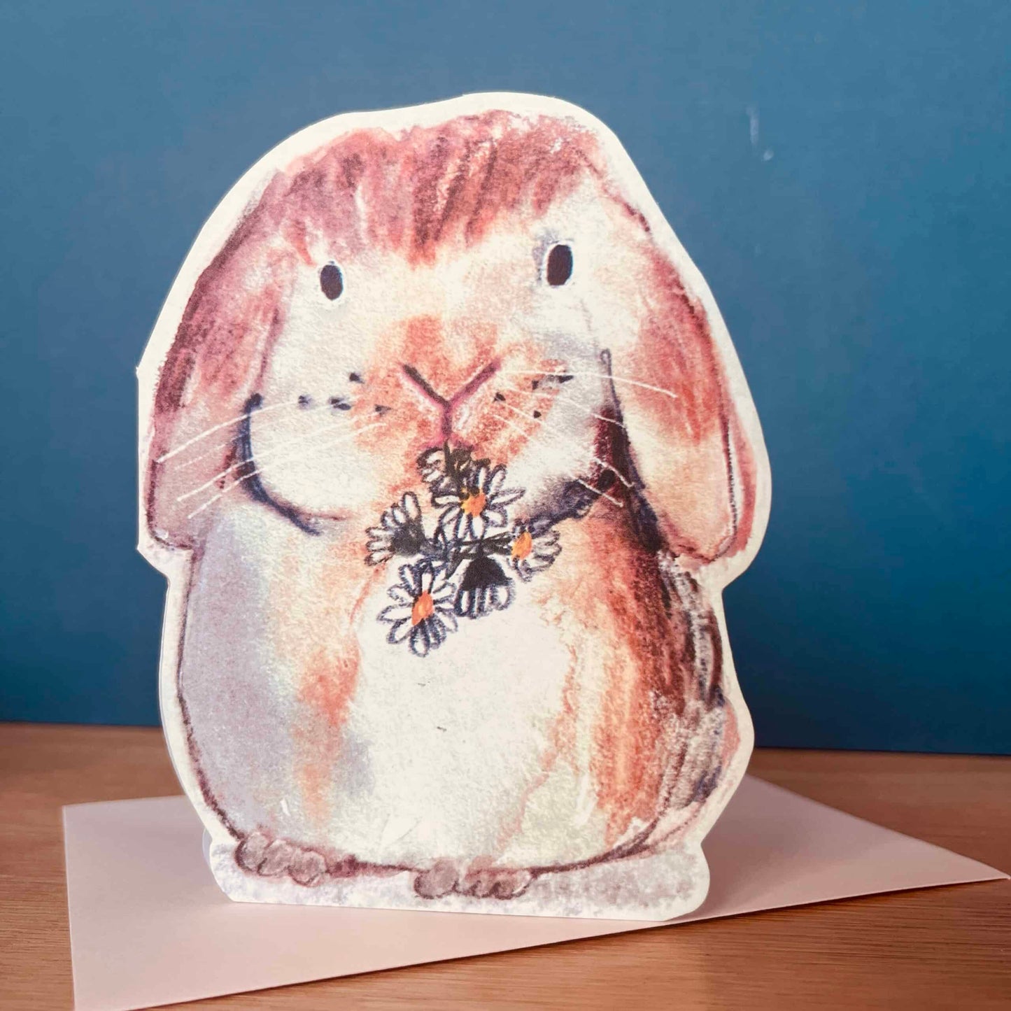 Handmade bunny greeting card featuring a rabbit chewing on daisies by Laura Skillbeck