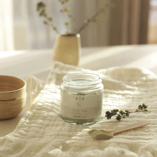 Elä Life Green French Clay in jar, with bamboo bowl and spatula. Perfect for a natural, purifying face mask ritual.