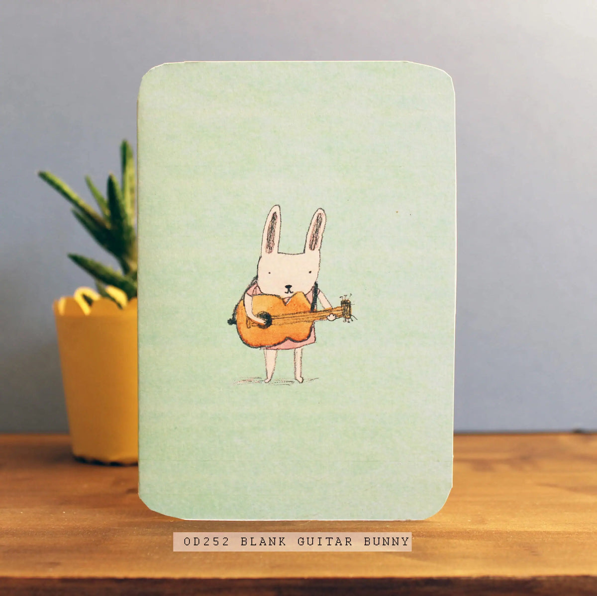 Laura Skillbeck greeting card with a rabbit playing guitar illustration. UK Made