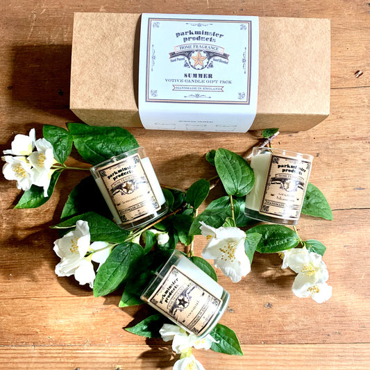 Gift set of three Parkminster summer-scented candles—Lemongrass, Coconut, and Orange Blossom—in clear glass votives, presented in a recycled kraft box with cream eco sleeve.