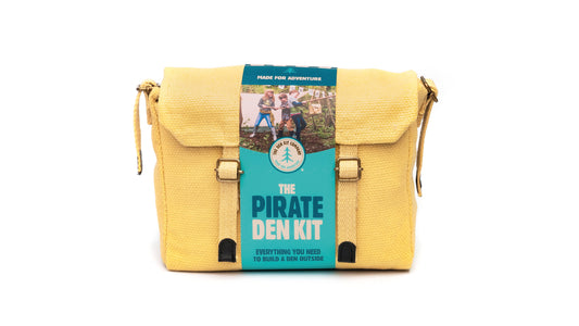 Pirate Den Kit including yellow cotton haversack, cotton calico tarpaulin, waterproof groundsheet, handmade wooden mallet, jute rope, steel tent pegs, pirate eye patch, and Jolly Roger bunting.
