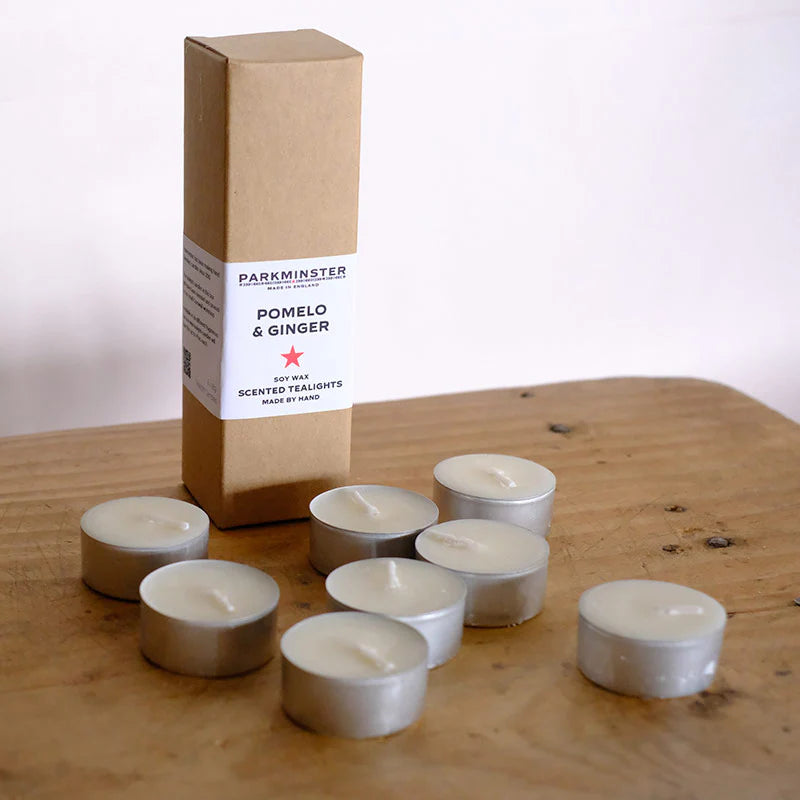 Set of eight Pomelo & Ginger scented tealights, showing natural soy wax, presented in eco-friendly packaging