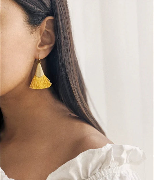 A bohemian style tassel earring. Handcrafted using recycled nickel-free brass and recycled sari threads. Shown on model, wearing yellow ones.