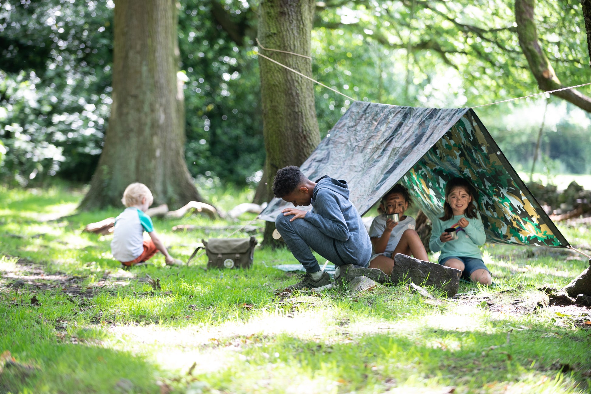 Children at play inside and outside of their Den.