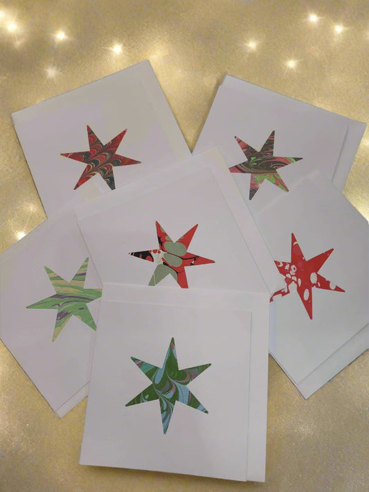 Handmade marbled cards, from local Herne Hill card designer Jane Darling. Featuring a cut out marble star, which makes it perfect as a beautiful handcrafted Christmas card.

Featuring a cut out shape with a marbled insert, in a variety of colourways, each card is unique.
14 x 14 cm